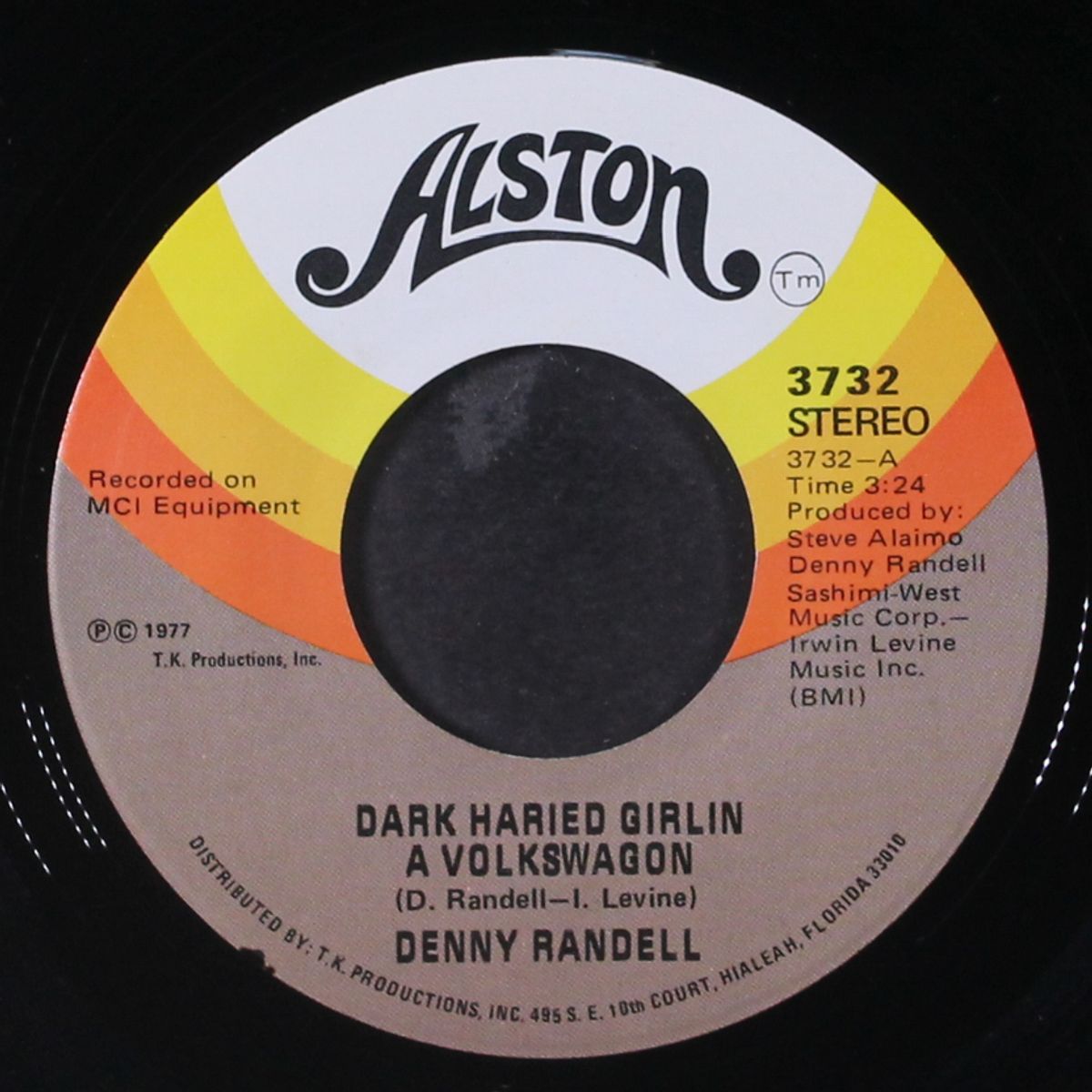 dark haired girl in a volkswagon / just hangin' out by DENNY RANDELL