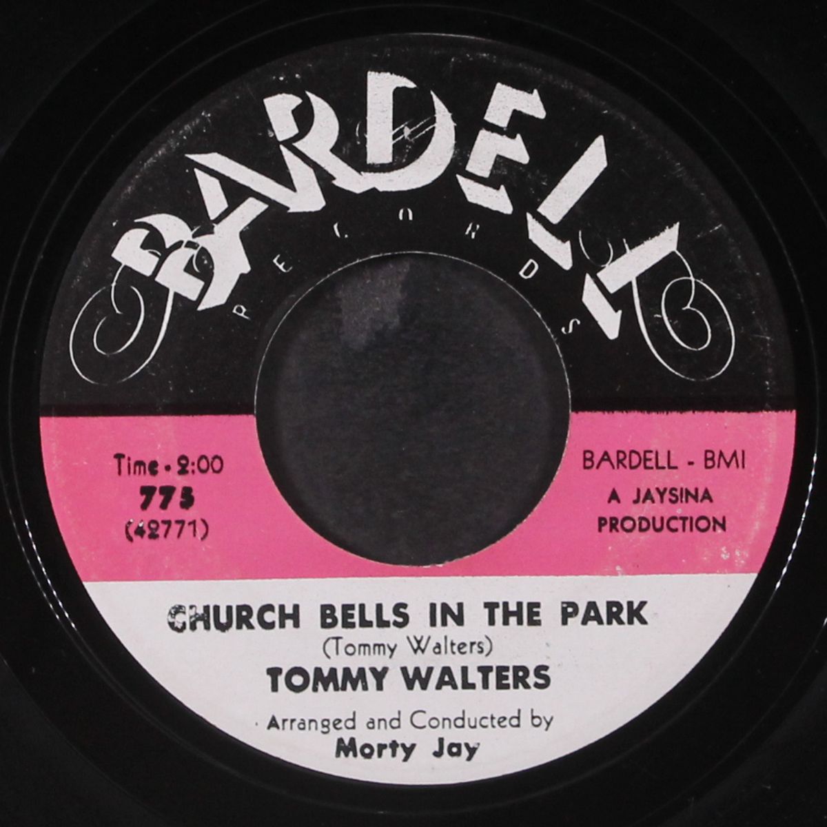 a red 'n yella' beach umbrella / church bells in the park by TOMMY WALTERS