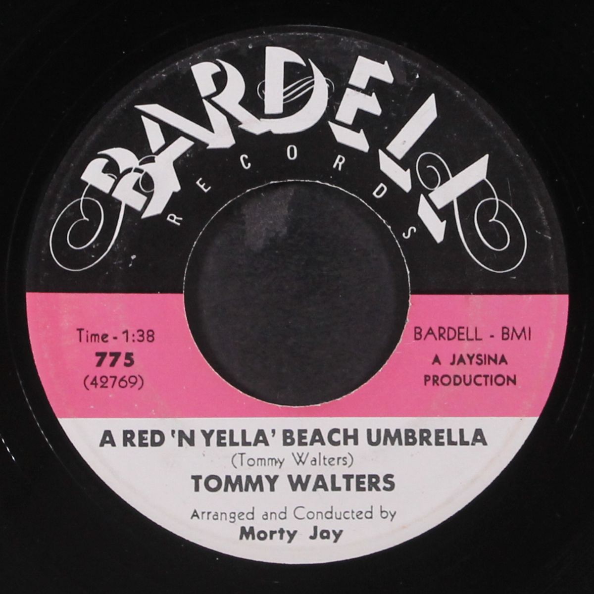 a red 'n yella' beach umbrella / church bells in the park by TOMMY WALTERS