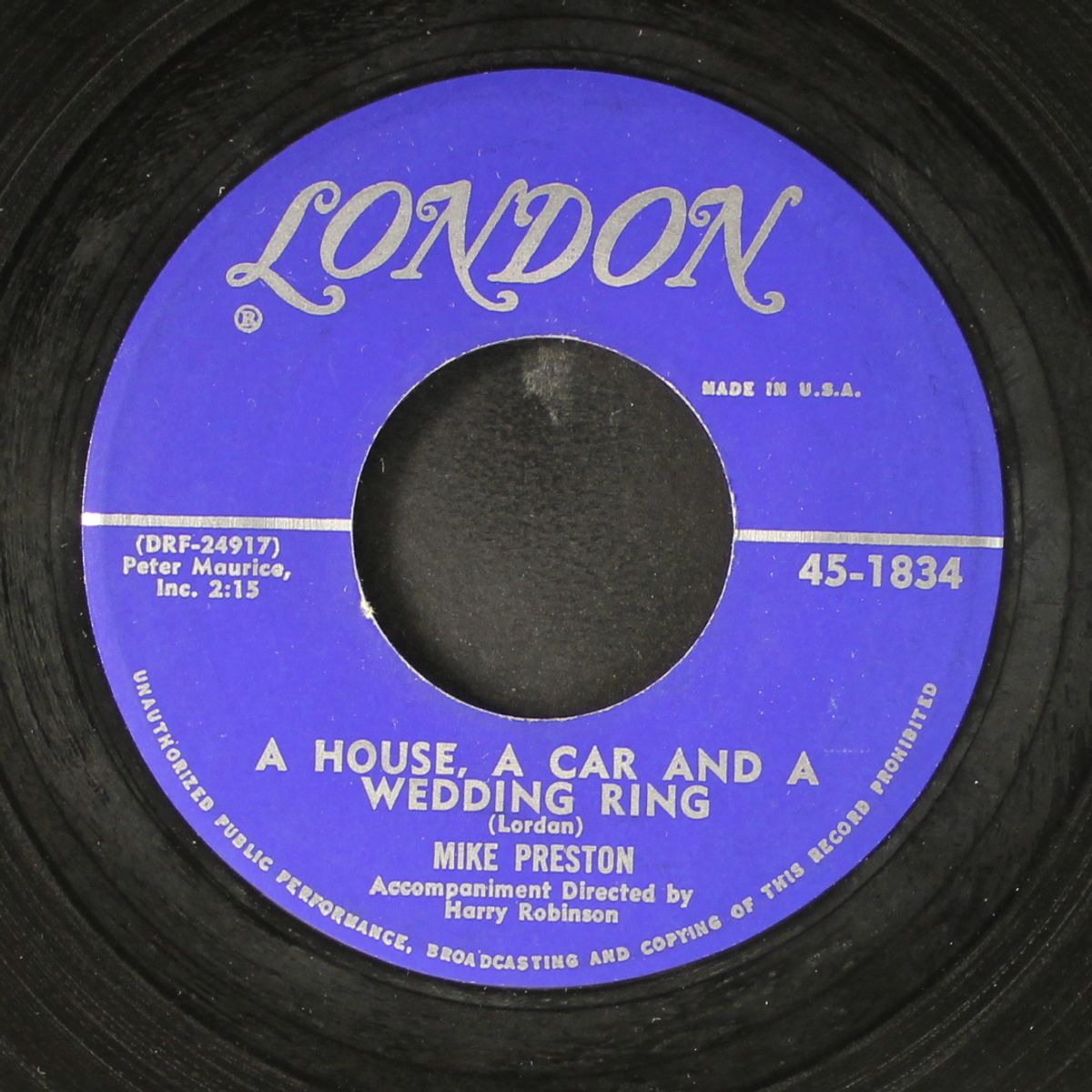 a house, a car and a wedding ring / in surabaya by MIKE PRESTON