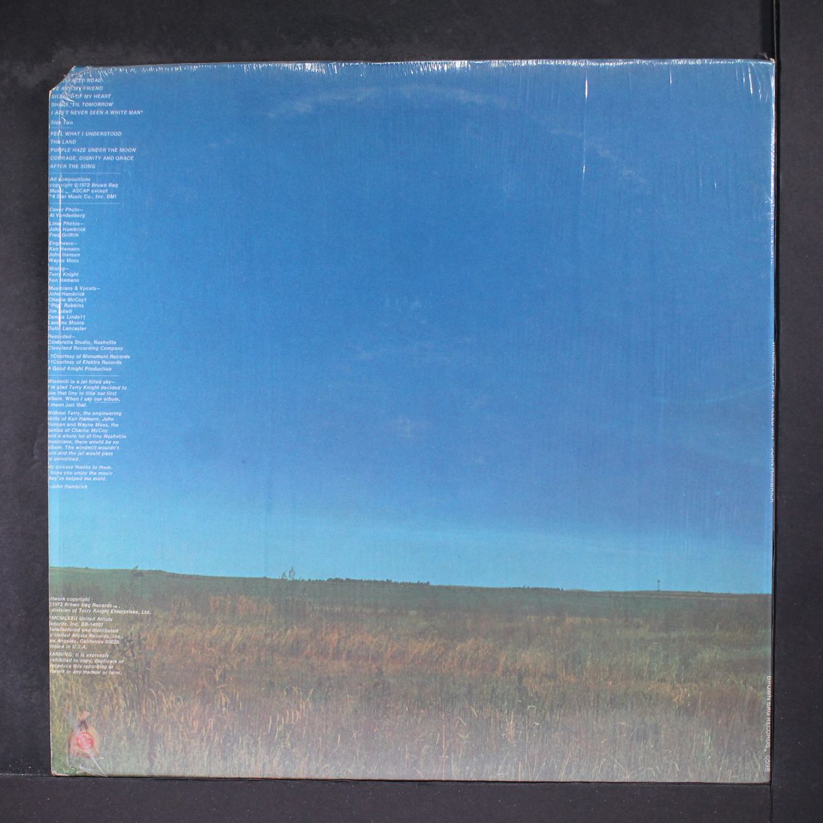 windmill in a jet filled sky by JOHN HAMBRICK