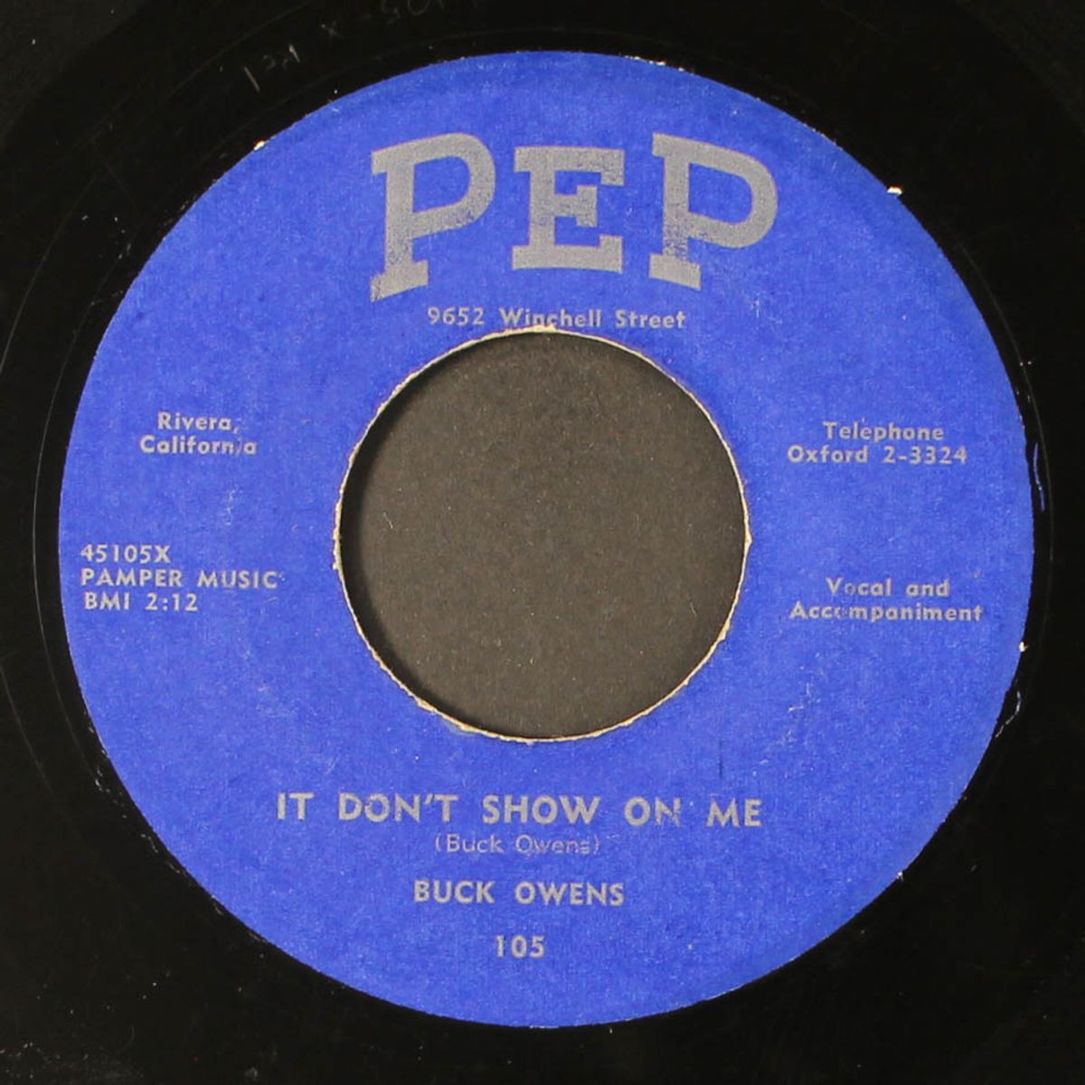 it don't show on me / down on the corner of love by BUCK OWENS