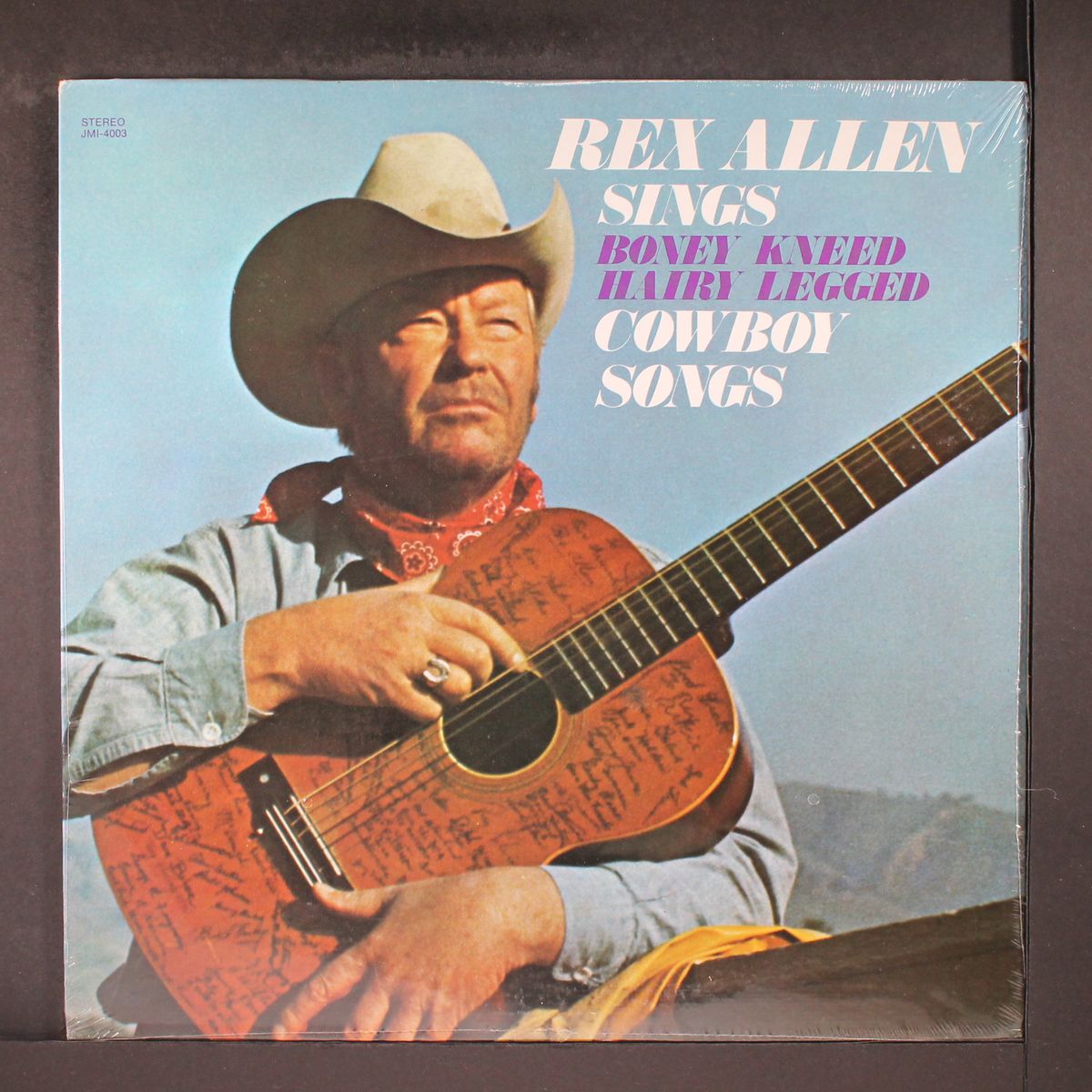 sings boney kneed hairy legged cowboy songs by REX ALLEN