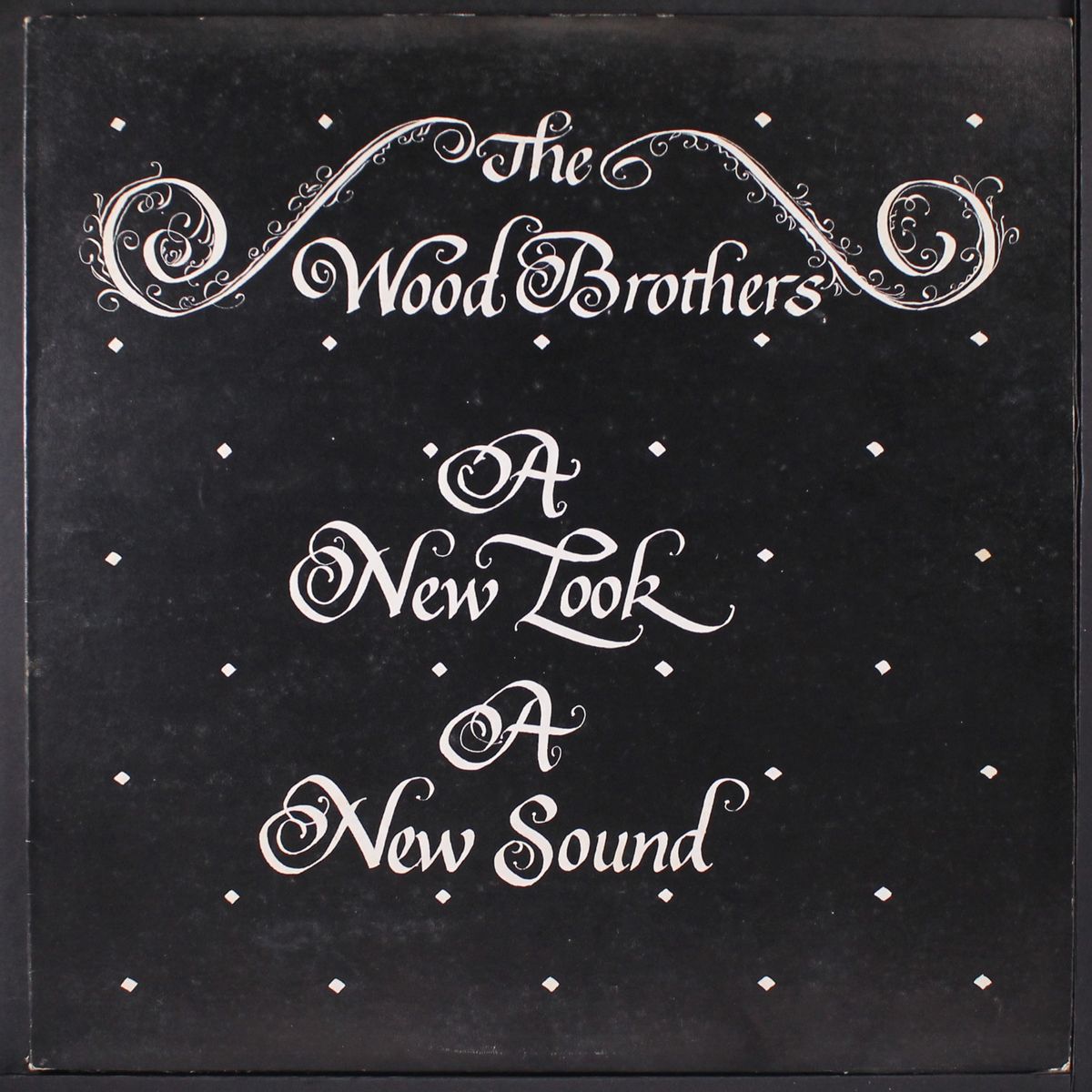 a new look, a new sound by WOOD BROTHERS