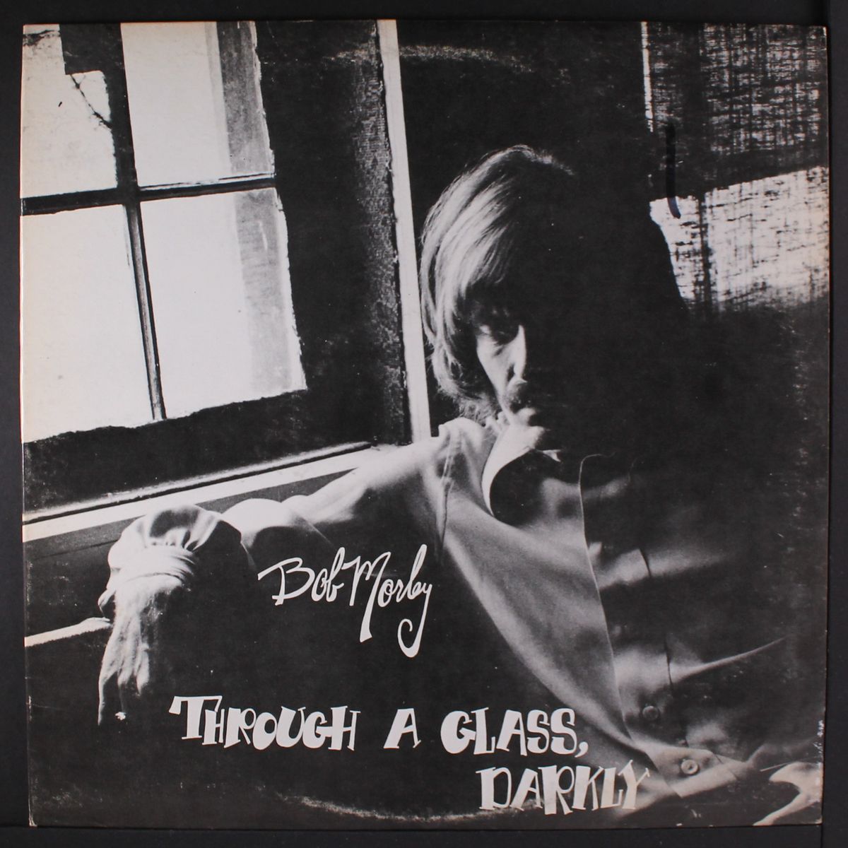 through a glass, darkly by BOB MORLEY