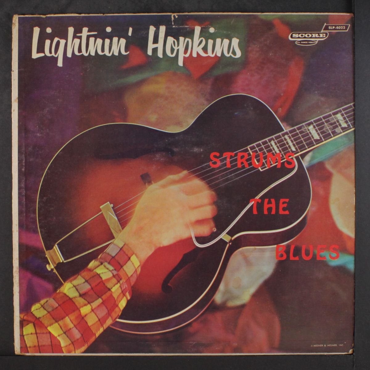 strums the blues by LIGHTNIN' HOPKINS